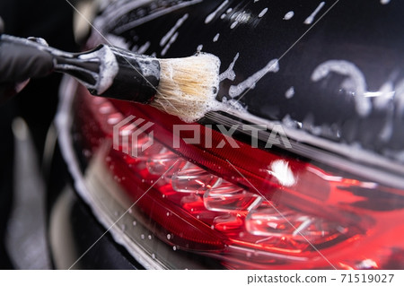 Car detailing studio worker cleaning car with brush Car detailing studio worker cleaning car with brush 71519027