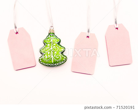 Three pink clear tags and decorative Chrsitmas tree on white background. Glamorous labels on silver threads with copy space. New Year symbol of sale and shopping. Top view, flat lay. Three pink clear tags and decorative Chrsitmas tree on white background. Glamorous labels on silver threads with copy space. New Year symbol of sale and shopping. Top view, flat lay. 71520191