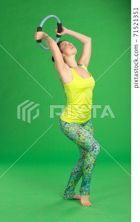 Woman doing pilates with ring Woman doing pilates with ring 71521351