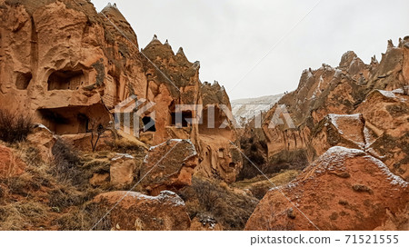 Cave houses and monasteries carved into Tufa Rocks at Zelve Open Air Museum (Zelve Valley) in winter season in Cappadocia, Turkey Cave houses and monasteries carved into Tufa Rocks at Zelve Open Air Museum (Zelve Valley) in winter season in Cappadocia, Turkey 71521555
