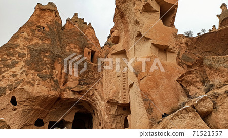 Cave houses and monasteries carved into Tufa Rocks at Zelve Open Air Museum (Zelve Valley) in winter season in Cappadocia, Turkey Cave houses and monasteries carved into Tufa Rocks at Zelve Open Air Museum (Zelve Valley) in winter season in Cappadocia, Turkey 71521557