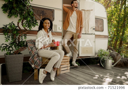 Love couple relaxing in rv, camping in a trailer 71521996