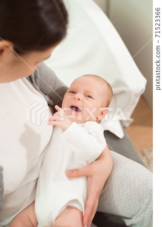 a small baby cries in her mother s arms a small baby cries in her mother s arms 71523366
