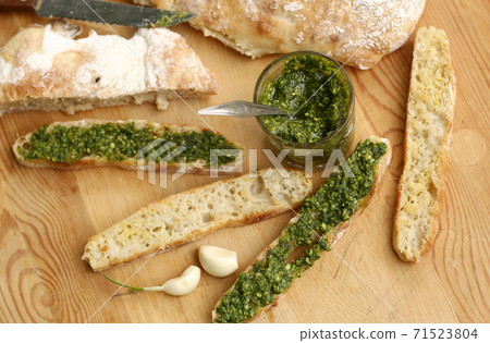 pesto sauce, sliced roasted italian ciabatta bread for cooking bruschetta sandwiches pesto sauce, sliced roasted italian ciabatta bread for cooking bruschetta sandwiches 71523804
