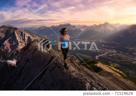 Adventurous Girl is hiking up a rocky mountain. Adventurous Girl is hiking up a rocky mountain. 71524629
