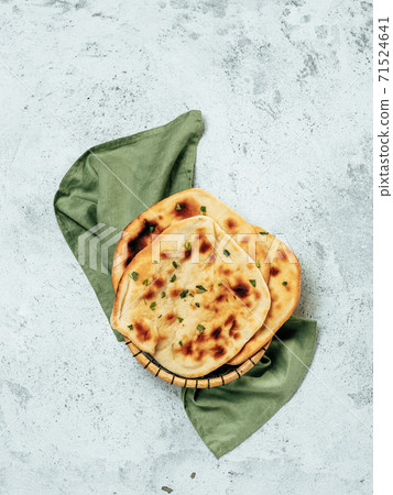 naan flatbreads on gray cement, copyspace vertical 71524641