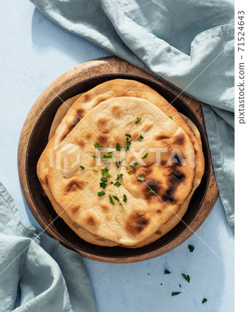 naan flatbread on blue, copy space, top view naan flatbread on blue, copy space, top view 71524643