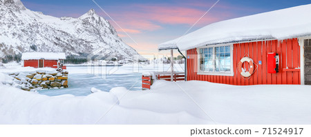 Stunning winter scenery with traditional Norwegian red wooden houses on the shore of Rolvsfjord Stunning winter scenery with traditional Norwegian red wooden houses on the shore of Rolvsfjord 71524917