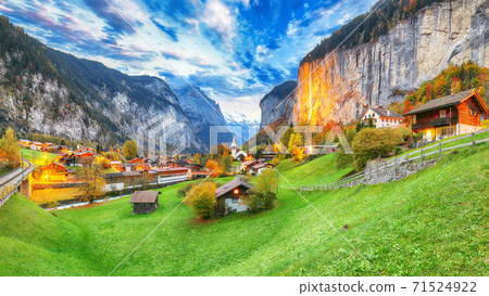 Dramatic autumn view of Lauterbrunnen valley with gorgeous Staubbach waterfall and Swiss Alps Dramatic autumn view of Lauterbrunnen valley with gorgeous Staubbach waterfall and Swiss Alps 71524922