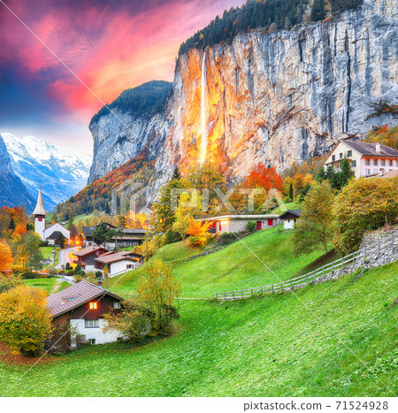 Captivating autumn view of Lauterbrunnen valley with gorgeous Staubbach waterfall and Swiss Alps Captivating autumn view of Lauterbrunnen valley with gorgeous Staubbach waterfall and Swiss Alps 71524928