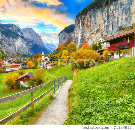 Astonishing autumn view of Lauterbrunnen valley with gorgeous Staubbach waterfall and Swiss Alps Astonishing autumn view of Lauterbrunnen valley with gorgeous Staubbach waterfall and Swiss Alps 71524932