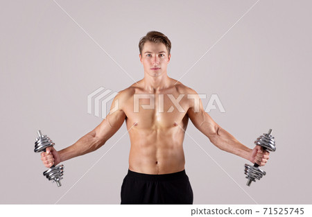 Strength training concept. Fit young guy with... - Stock Photo [71525745] -  PIXTA