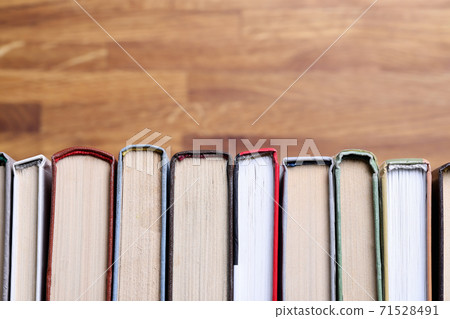 There are books in row on table closeup There are books in row on table closeup 71528491