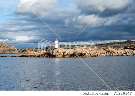A beautiful lighthouse outside a fishing village on the Swedish Atlantic coast. Picture from Hamburgsund, Vastra Gotaland county, Sweden 71529147
