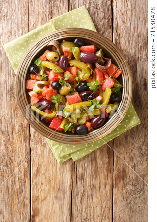 Tomato and green pepper salad Chlada felfel recipe close-up in a bowl. vertical  top view 71530478