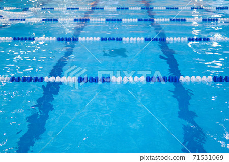 fragment of the competition pool with blue water and marked swimming lanes 71531069
