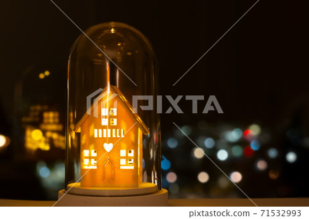 Fairy Christmas house with candlelight inside, background lights. Light up decoration, house shape with the bokeh lights on the dark background. Cristmas mood, winter decoration on window. Fairy Christmas house with candlelight inside, background lights. Light up decoration, house shape with the bokeh lights on the dark background. Cristmas mood, winter decoration on window. 71532993