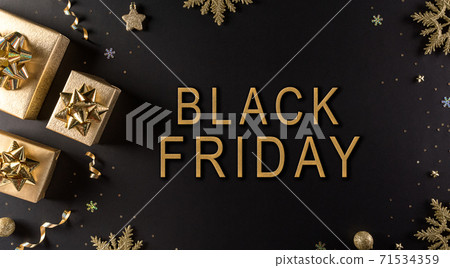 Top view of golden christmas boxes on black background with copy space for text. Black Friday Sale, Banner, poster composition. 71534359