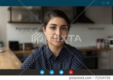 Beautiful young happy indian ethnicity woman holding video call. Beautiful young happy indian ethnicity woman holding video call. 71534730