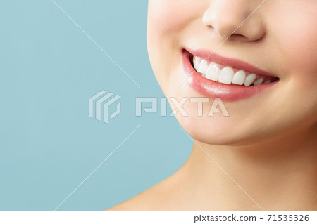 Perfect healthy teeth smile of a young woman. Teeth whitening. Stomatology concept. Perfect healthy teeth smile of a young woman. Teeth whitening. Stomatology concept. 71535326