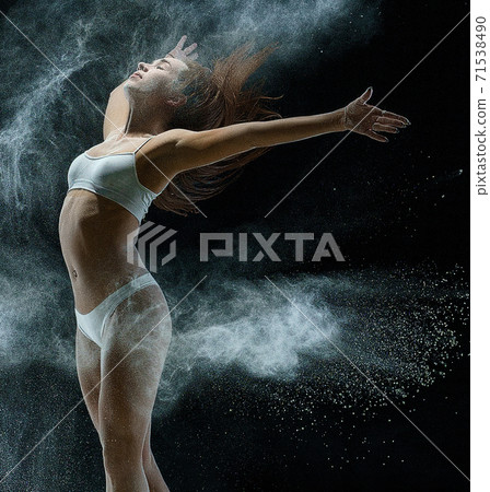 Girl in a cloud of white dust studio portrait 71538490