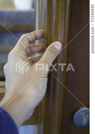 Hand on opening a wooden door Hand on opening a wooden door 71540930