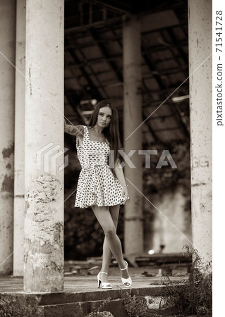 Young model posing in the ruined building 71541728