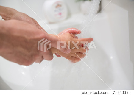 Hands of children and adults to wash their hands 71543351