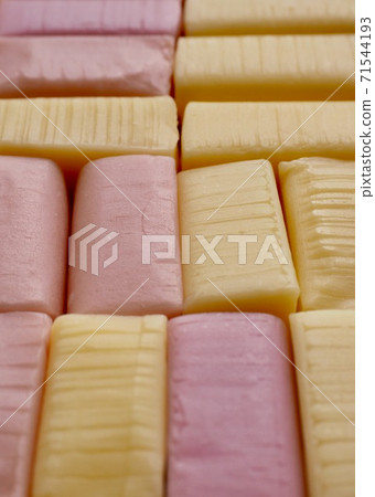 Yellow and pink square shaped candy background 71544193