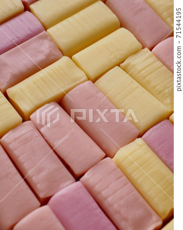 Yellow and pink square shaped candy background 71544195