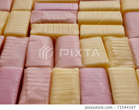 Yellow and pink square shaped candy background 71544197