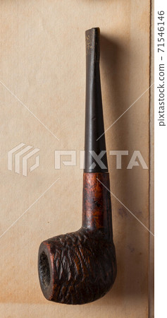 Ancient smoking pipe on old paper background. Ancient smoking pipe on old paper background. 71546146