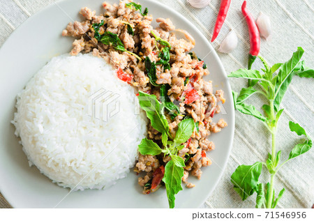 Rice topped with stir-fried pork. 71546956