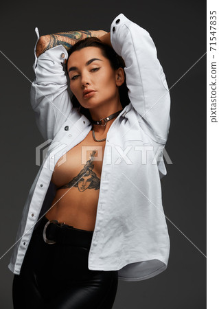 Premium Photo  Beautiful young sexy fashion model posing in bra and  undressing her white t shirt and looking at camera with passion. indoor,  studio shot on gray background