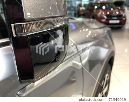 Wing mirror of a brand new car in the dealership, close-up shot 71549019