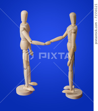 Wooden toy figures handshake on blue 71550121