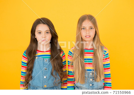 Kids sworn friends. Rivalry concept. small sisters trendy hairstyle. Hair Kids sworn friends. Rivalry concept. small sisters trendy hairstyle. Hair 71550966