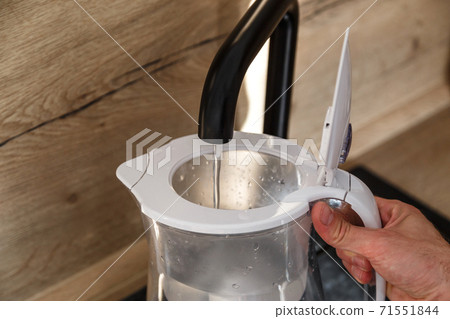 Water filter jug in kitchen sink, filling up. Water filter jug in kitchen sink, filling up. 71551844