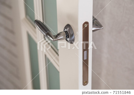 Wooden door with contemporary magnetic latch on modern interior. Wooden door with contemporary magnetic latch on modern interior. 71551846