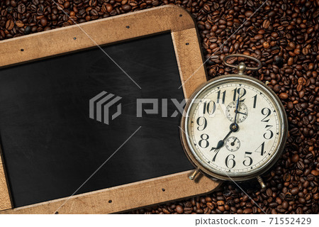 Alarm Clock on Roasted Coffee Beans and empty Blackboard 71552429