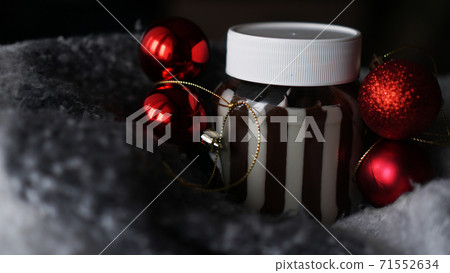 Sweet chocolate cream in the jar against Christmas background Sweet chocolate cream in the jar against Christmas background 71552634