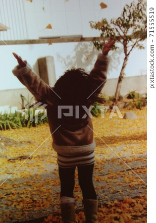 A child frolicking at the fallen leaves of a ginkgo tree at Inada Hachimangu, Higashi-Osaka A child frolicking at the fallen leaves of a ginkgo tree at Inada Hachimangu, Higashi-Osaka 71555519