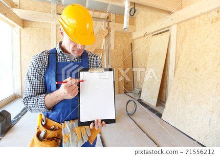 Worker showing document at site 71556212