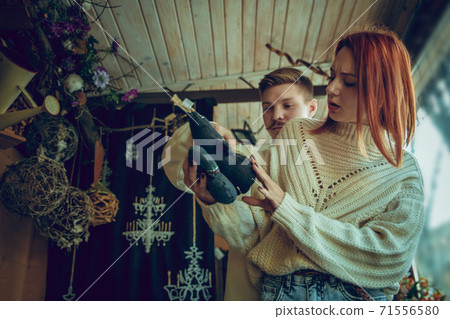 Smiling family, couple looking for home decoration and holiday's gifts in household store Smiling family, couple looking for home decoration and holiday's gifts in household store 71556580