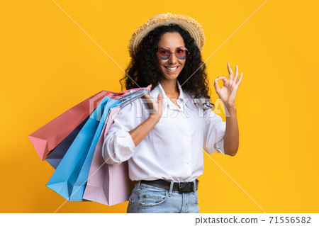 Big Sales. Stylish Brunette Woman In Hat Holding Shopping Bags And Showing Ok Sign 71556582