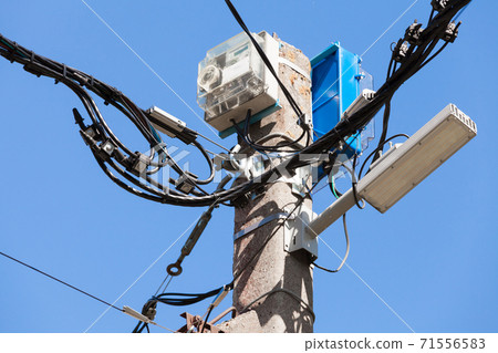 Power pole with light, electric meter and wires Power pole with light, electric meter and wires 71556583