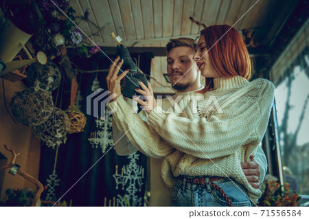 Smiling family, couple looking for home decoration and holiday's gifts in household store Smiling family, couple looking for home decoration and holiday's gifts in household store 71556584