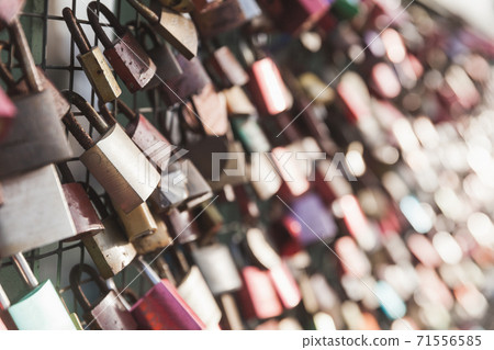 Love locks hang on a bridge railings Love locks hang on a bridge railings 71556585