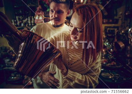 Smiling family, couple looking for home decoration and holiday's gifts in household store Smiling family, couple looking for home decoration and holiday's gifts in household store 71556662