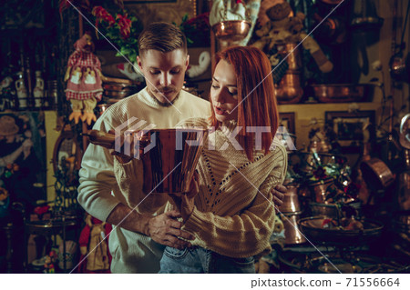 Smiling family, couple looking for home decoration and holiday's gifts in household store Smiling family, couple looking for home decoration and holiday's gifts in household store 71556664